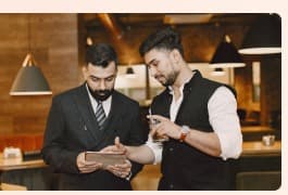 Restaurant staff reviewing a device together